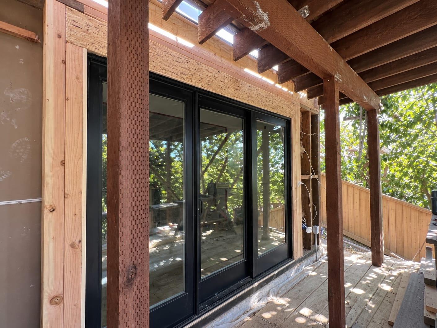 Same sliding door opening with a new engineered header and fresh framing installed by Gadget Construction